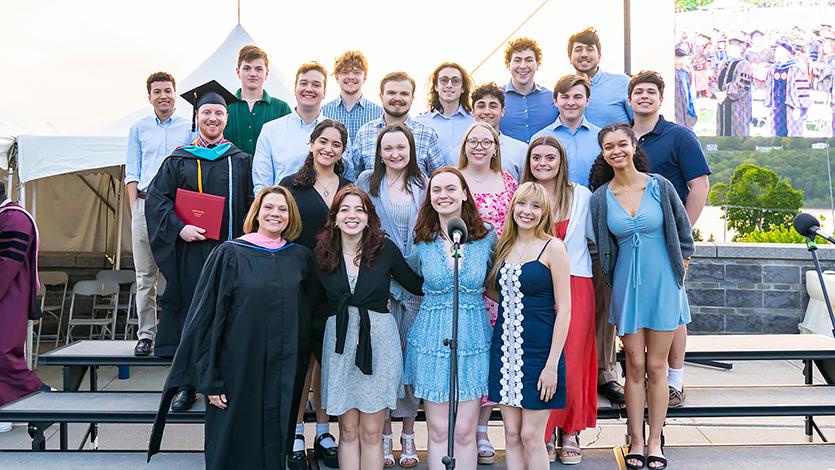 Image of Sarah and group of students at Commencement. 